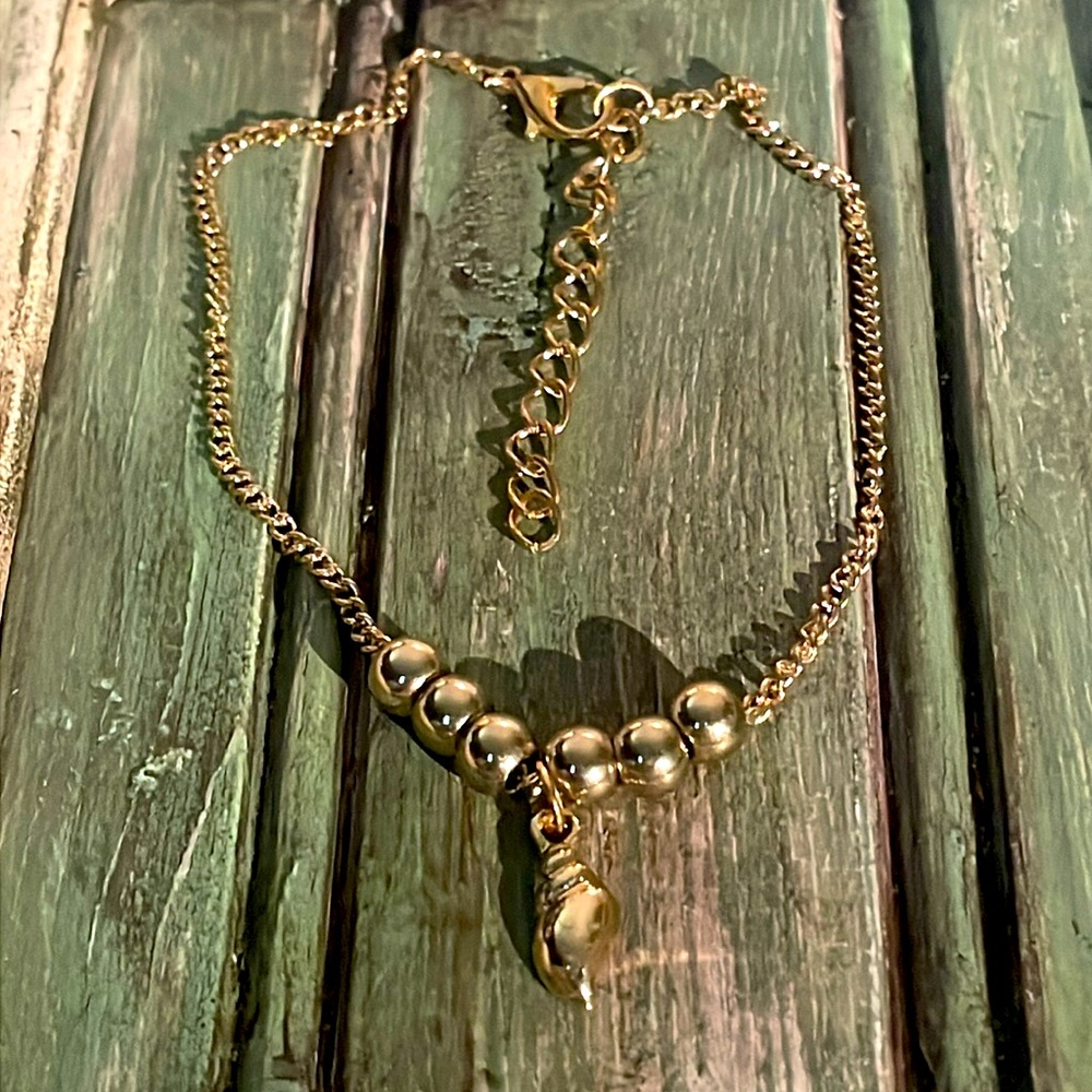 Goldtone shell charm bracelet